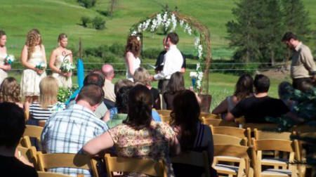 A group of people are sitting in chairs at a wedding ceremony.