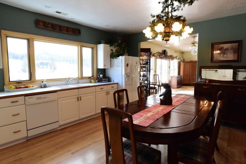A kitchen and dining room with a table and chairs