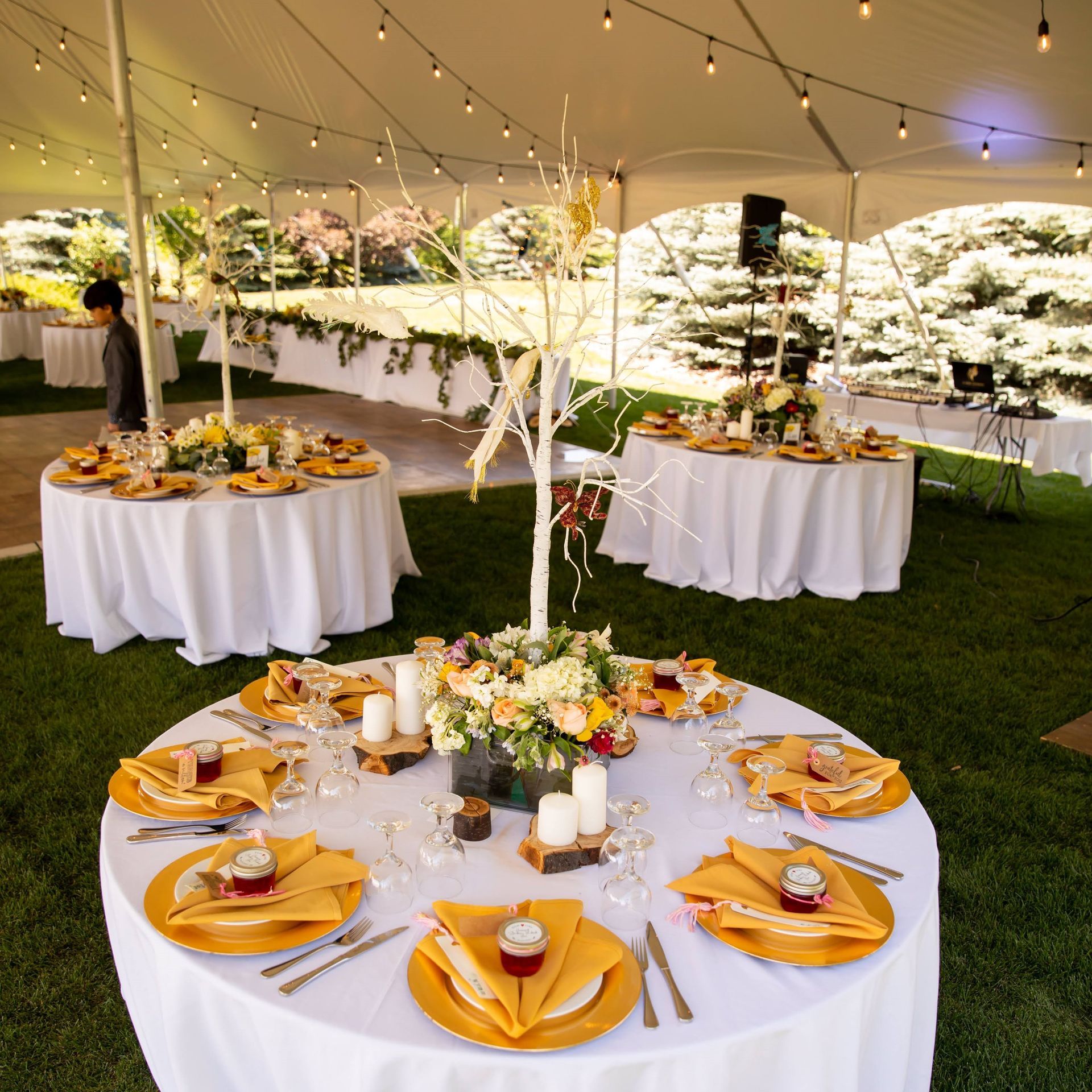 Tables set up for a wedding reception under a tent