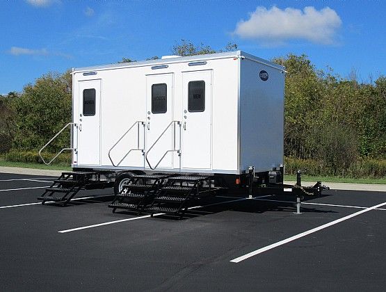 A white trailer is parked in a parking lot.