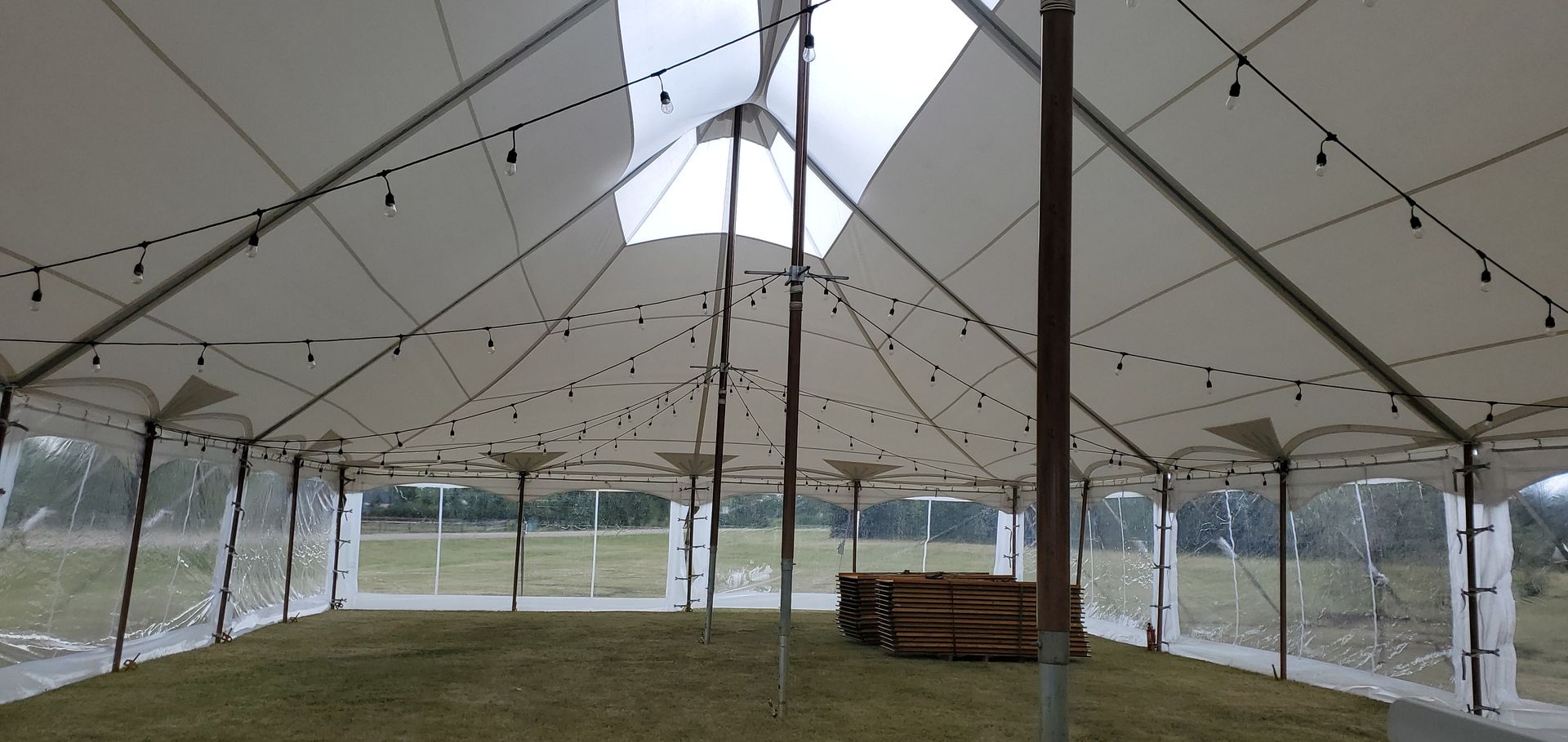 The inside of a large tent with a lot of lights hanging from the ceiling.