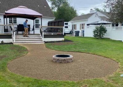 Man Standing Next to A Fire Pit in A Backyard — Erie, PA — Saldana Services LLC