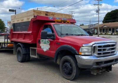 Red Truck Is Parked on Side of The Road — Erie, PA — Saldana Services LLC