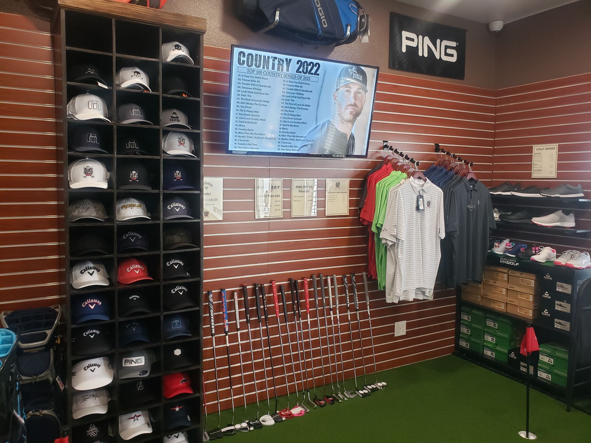 A ping sign hangs above a display of hats and shirts