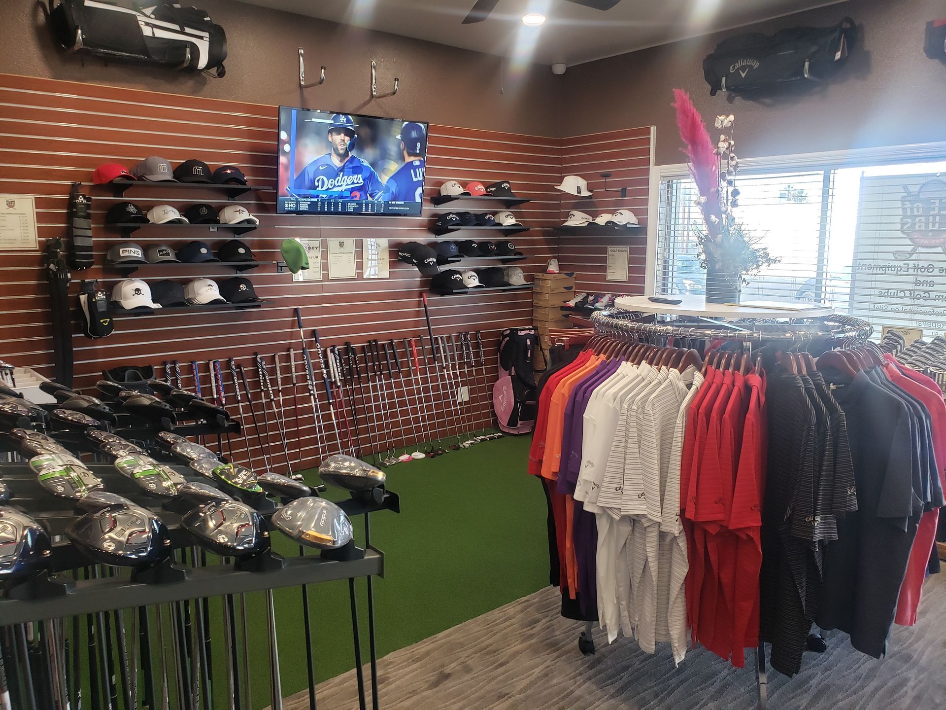 A store filled with lots of clothes and golf clubs.