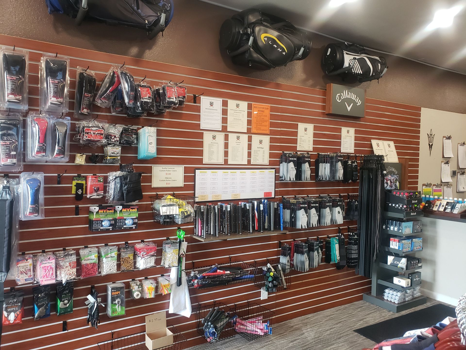 A store filled with lots of golf equipment including golf bags