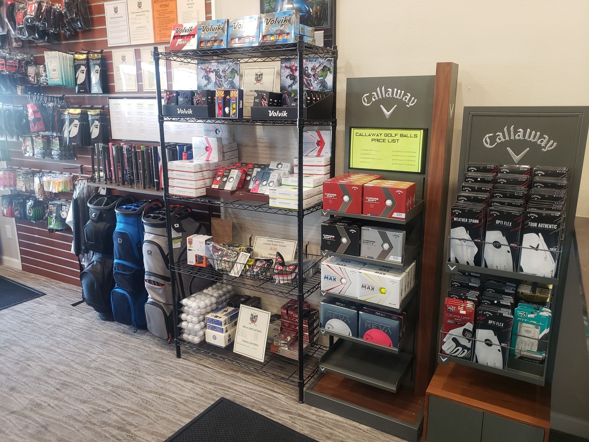 A store filled with lots of golf equipment and a display of golf balls.