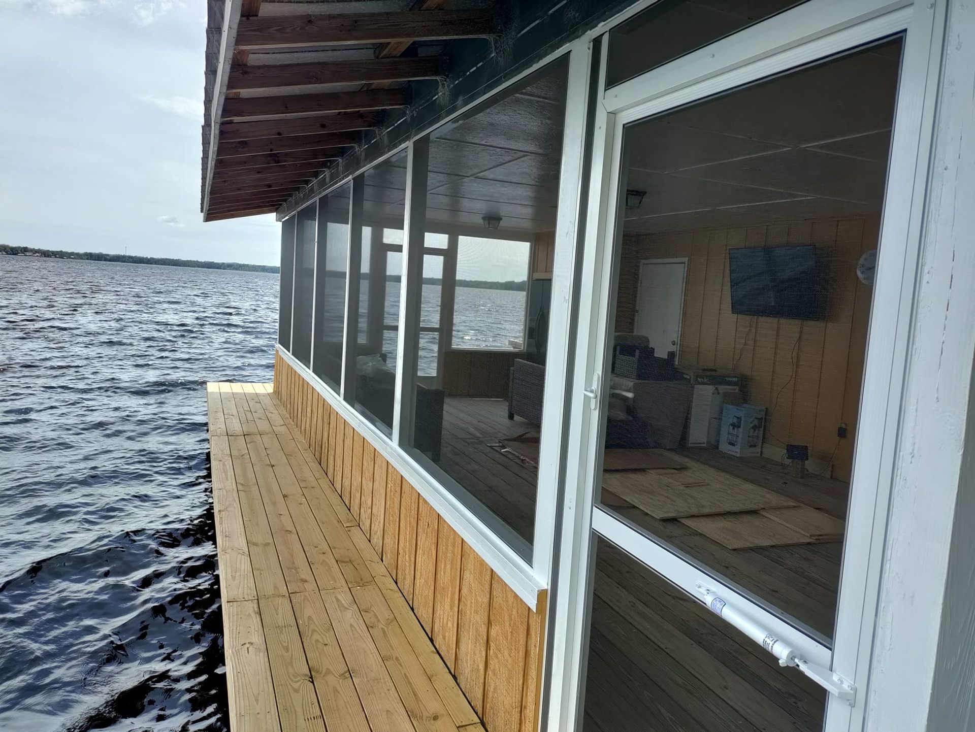 A screened in porch overlooking a body of water