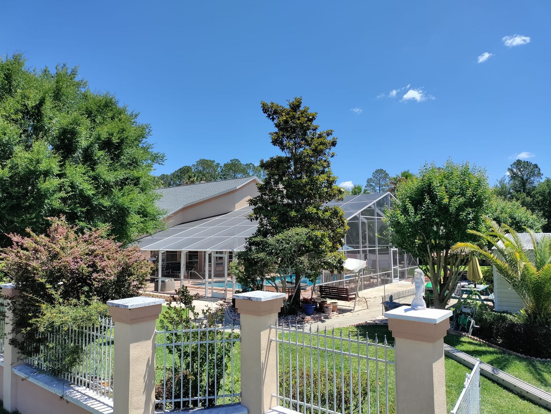 A house with a screened in porch and a swimming pool