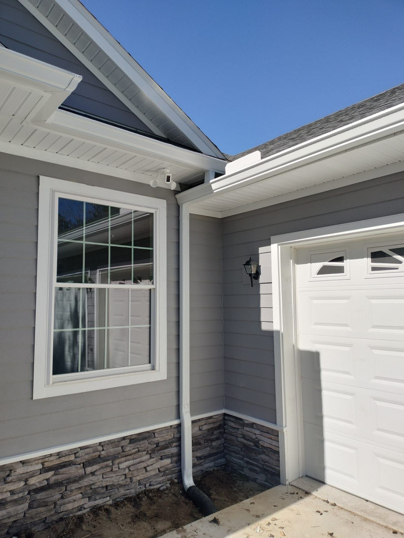 A house with a garage and a window on the side of it.