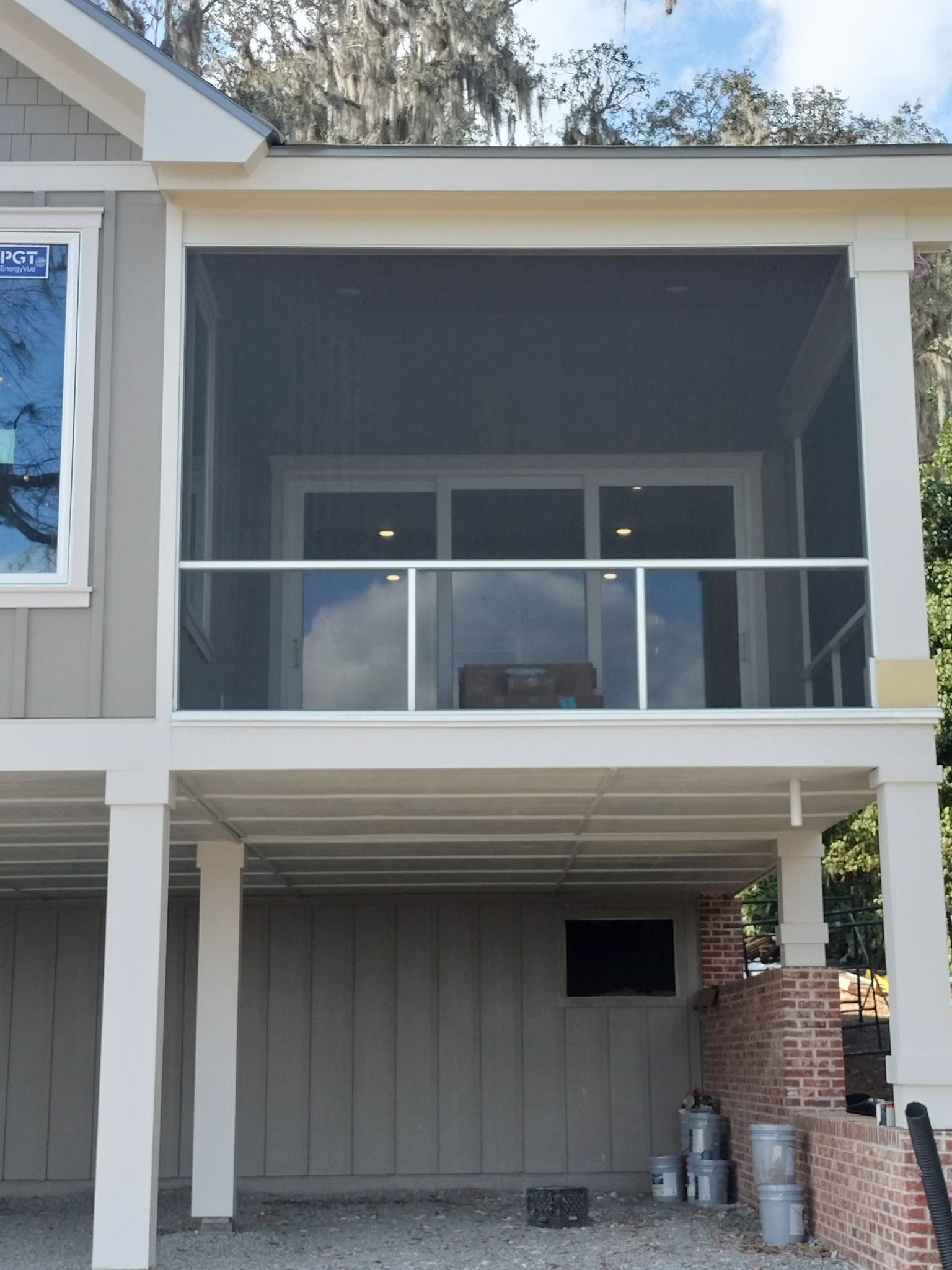 A house with a screened in porch and a balcony