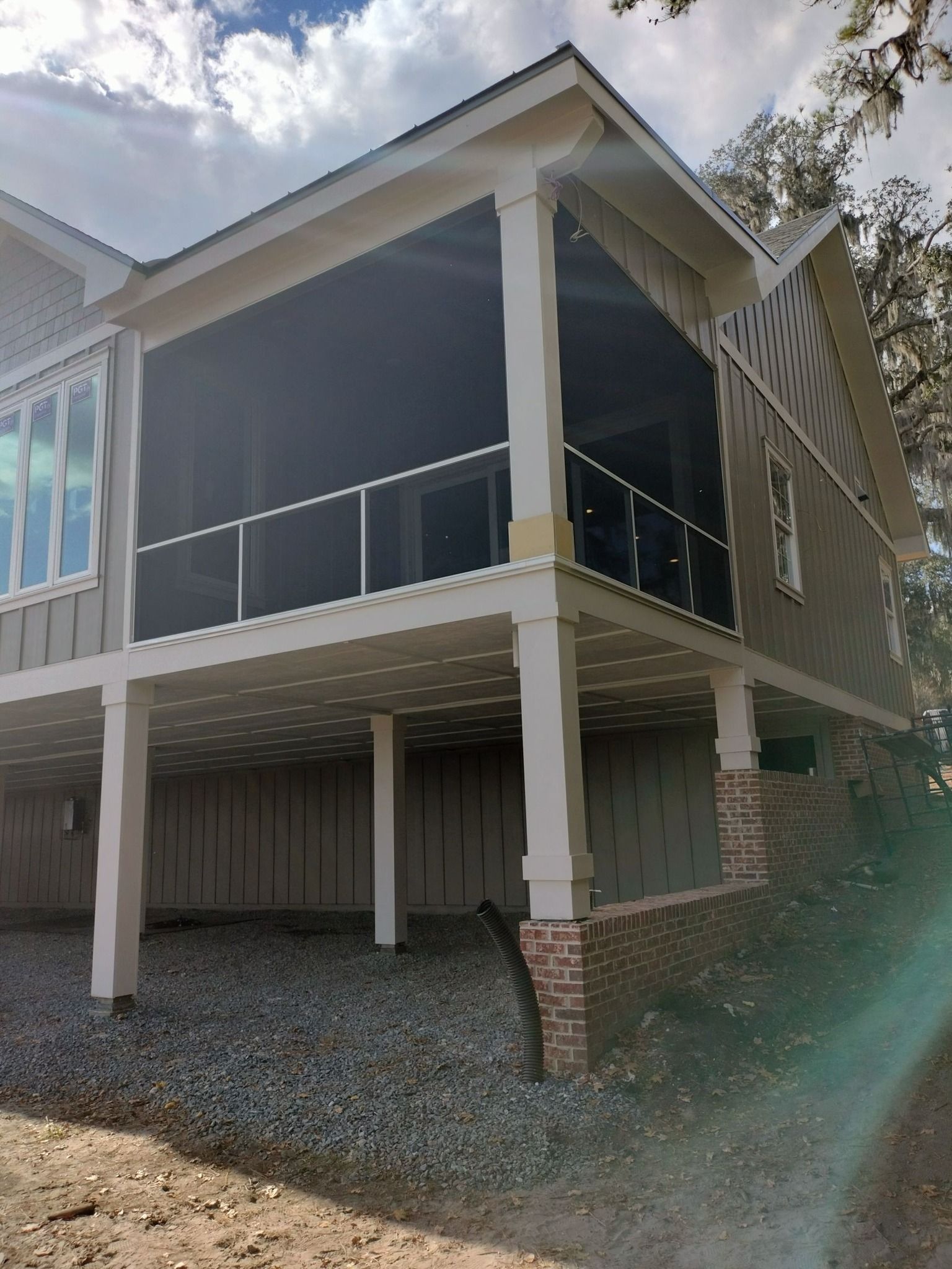 A large house with a screened in porch and balcony