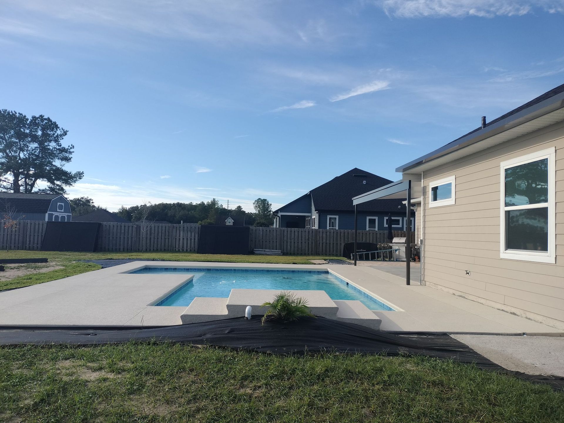 A house with a large swimming pool in the backyard