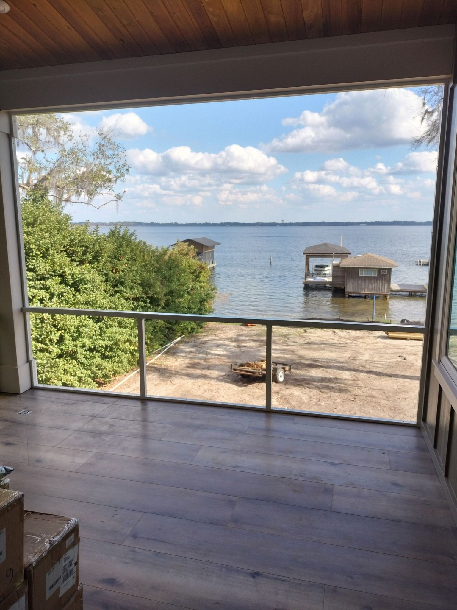 A room with a view of a lake and a dock.