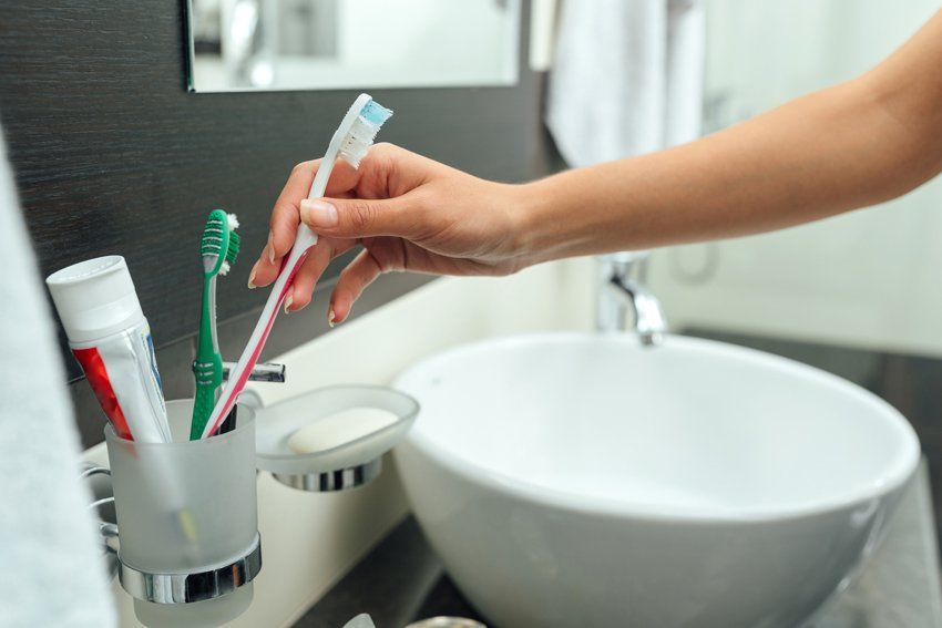Woman Takes A Toothbrush — Port Orange, FL — Advanced Dental Care