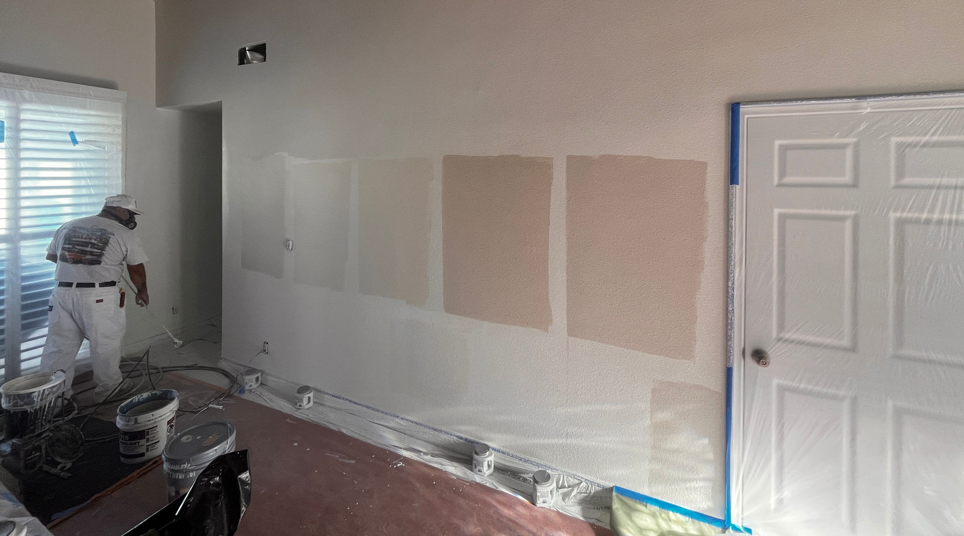 A white toilet in an ADA-compliant restroom with horizontal grab bars mounted on the walls.