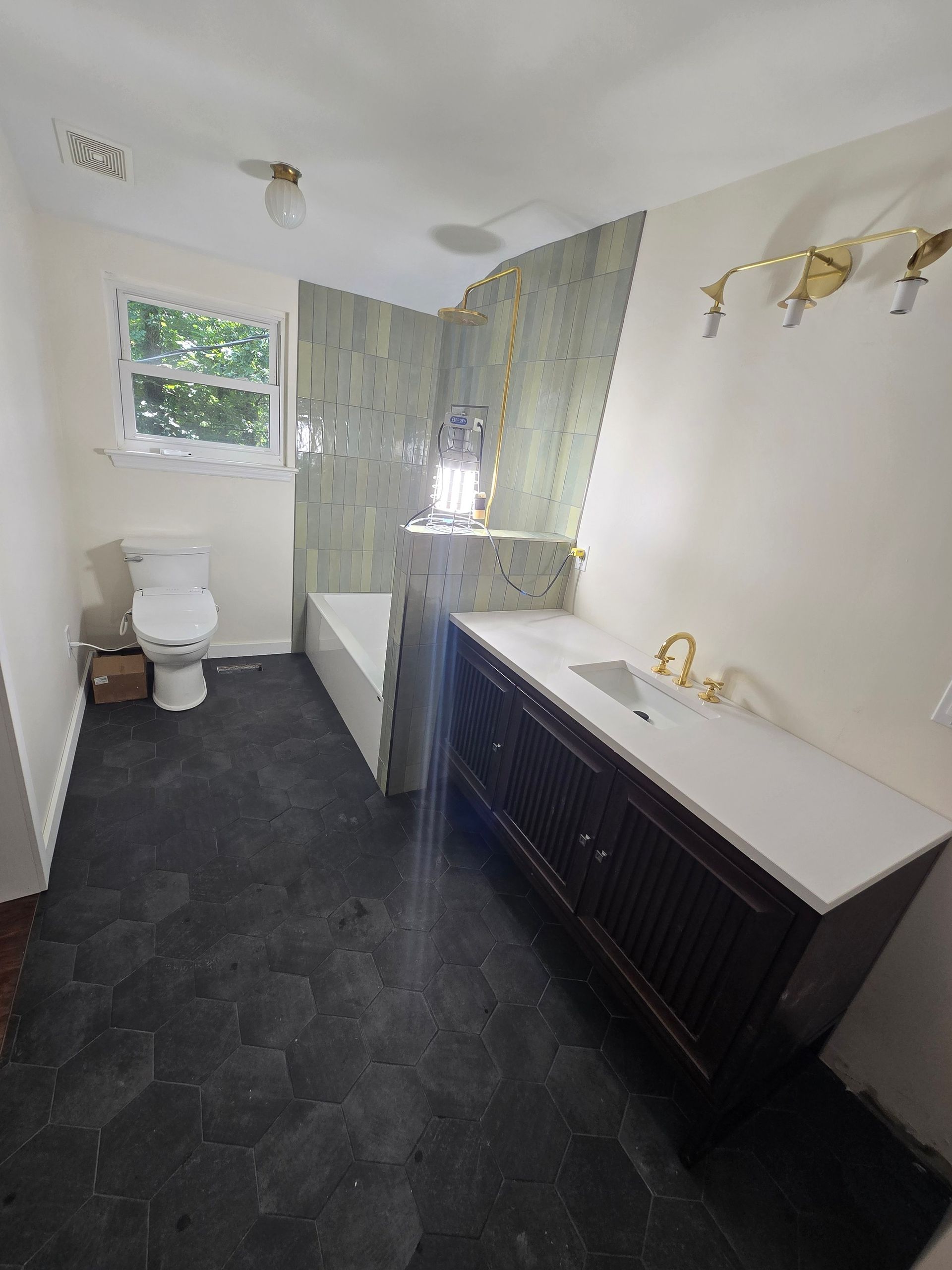 A bathroom with a toilet , sink , and bathtub.