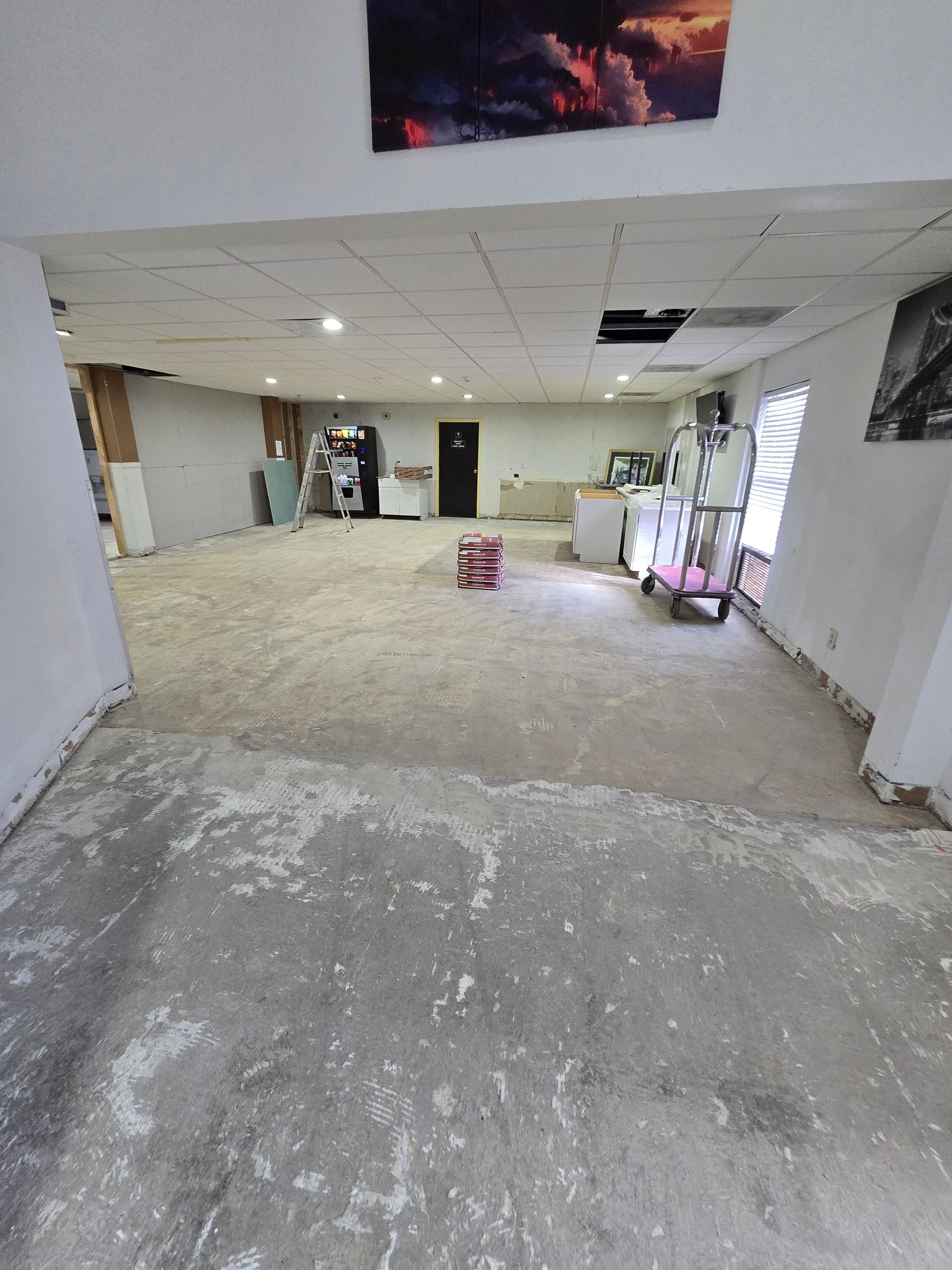 A large room with a concrete floor and white walls.