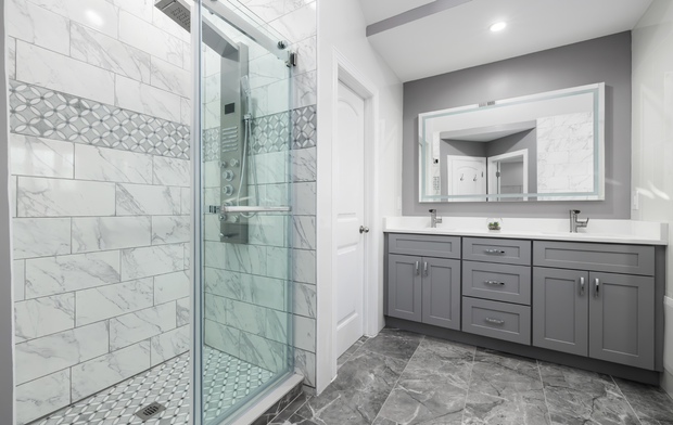 A bathroom with a walk in shower , sink and mirror.