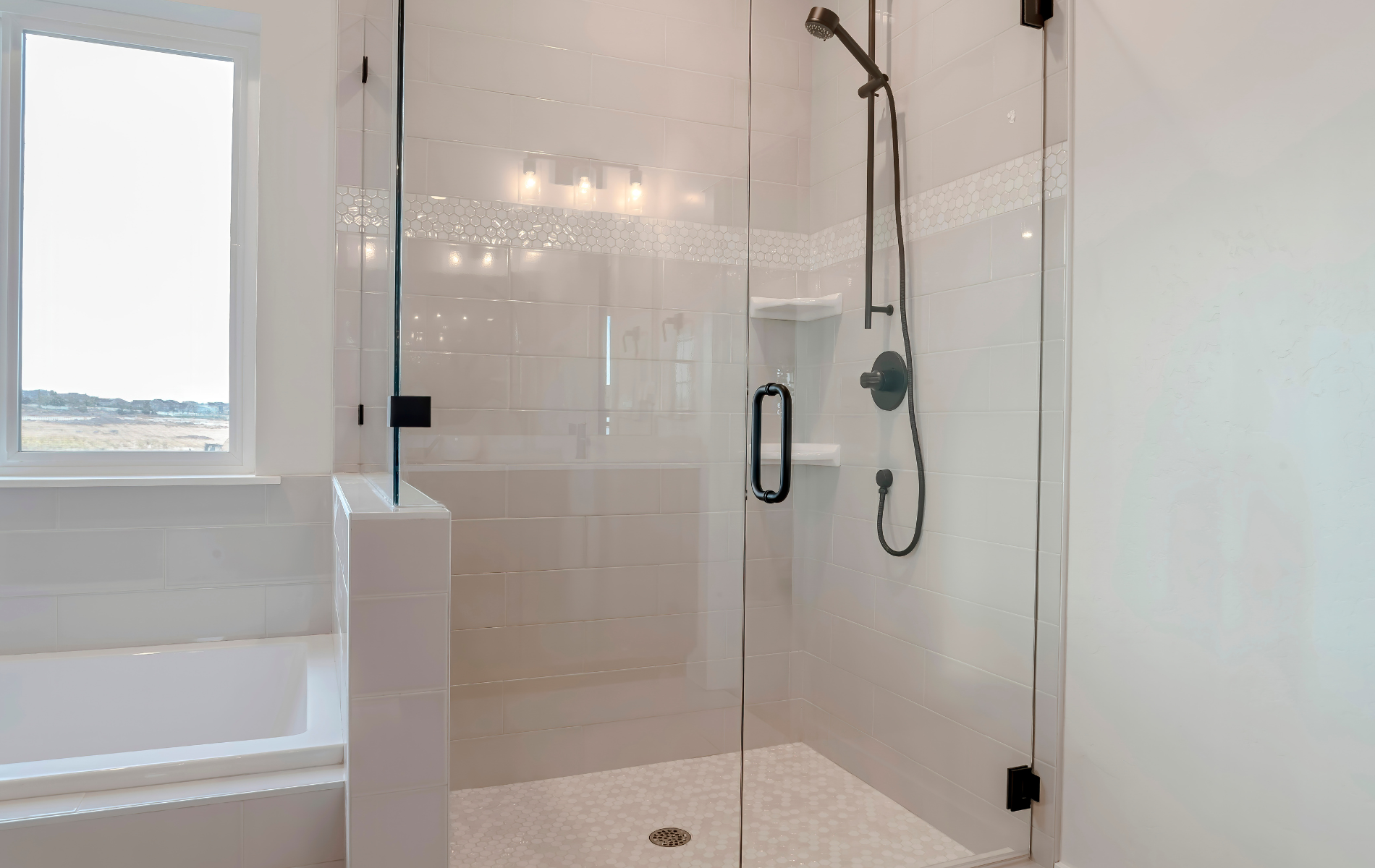 A bathroom with a walk in shower and a bathtub.