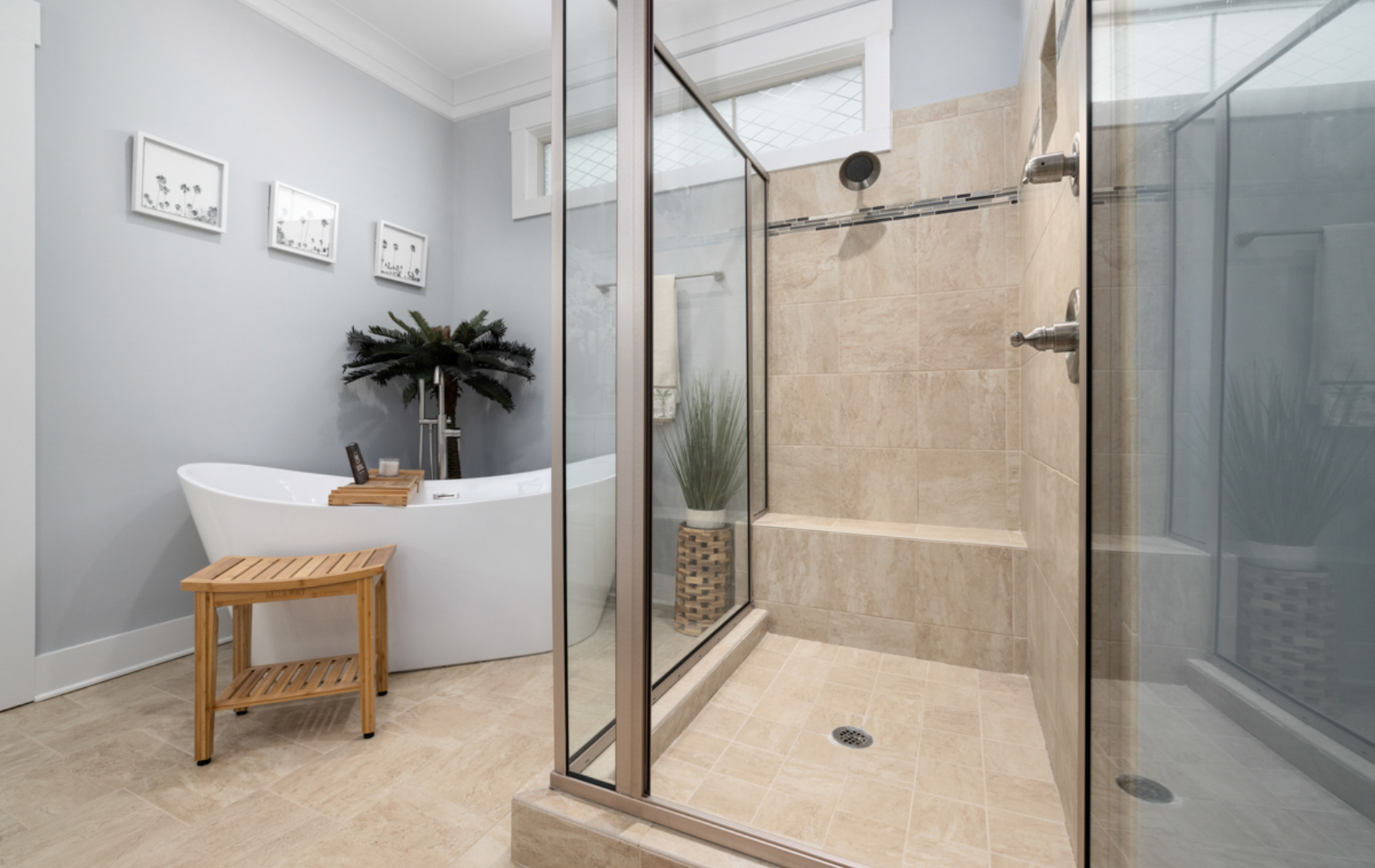 A bathroom with a bathtub and a walk in shower.