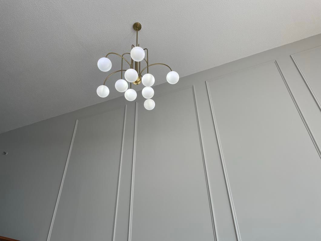 A chandelier is hanging from the ceiling in a room.