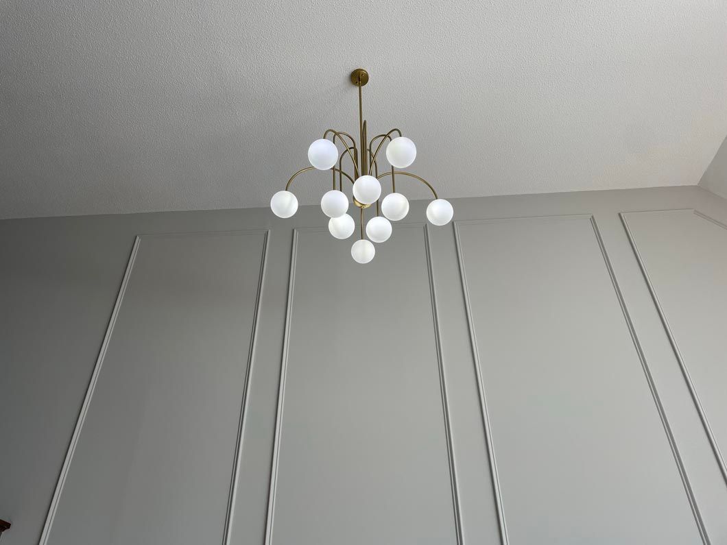 A chandelier is hanging from the ceiling in a room.