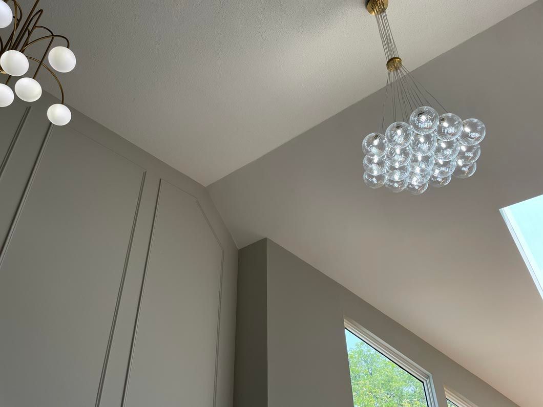 Looking up at the ceiling of a room with a chandelier hanging from it