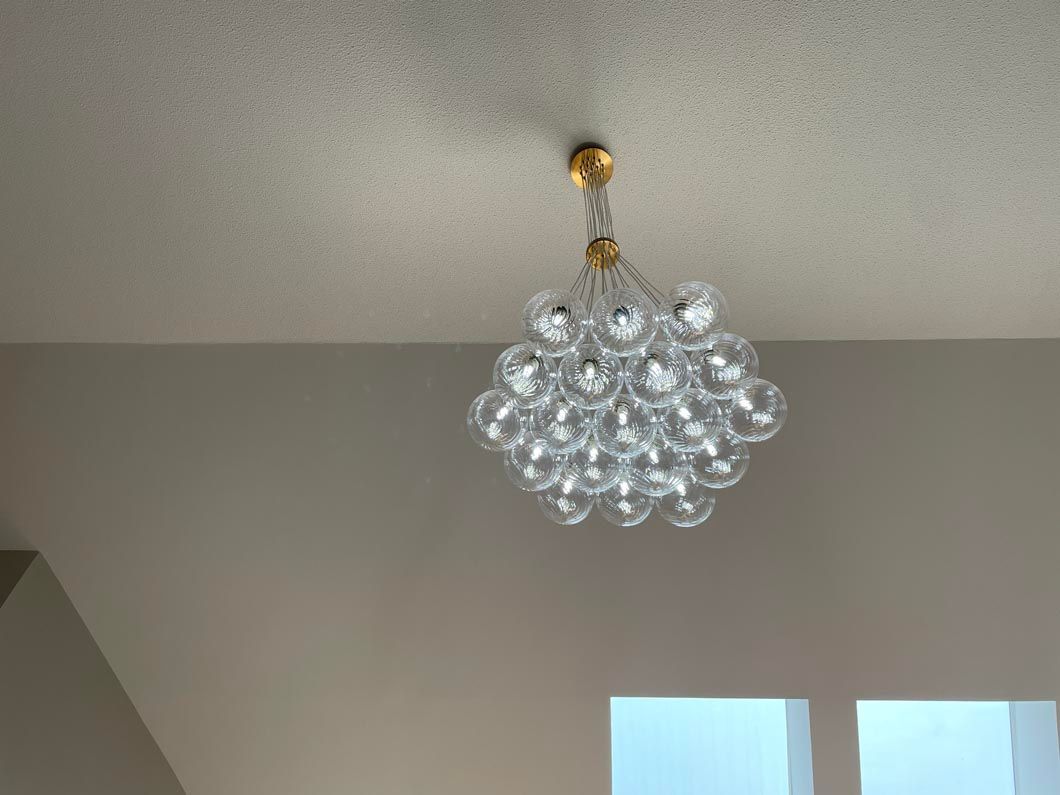 A chandelier is hanging from the ceiling in a room.