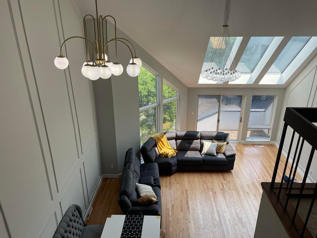 An aerial view of a living room with a couch and a chandelier