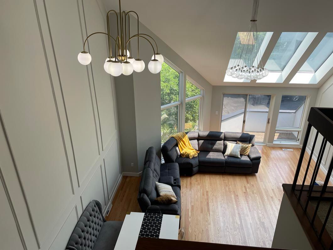 An aerial view of a living room with a couch and a chandelier.