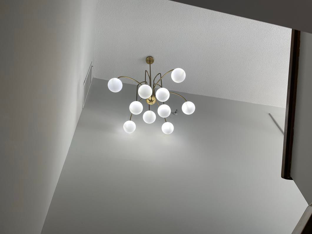 A chandelier is hanging from the ceiling in a room.