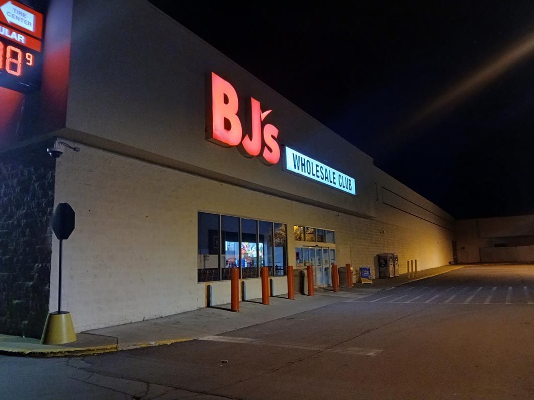 A bj 's store is lit up at night