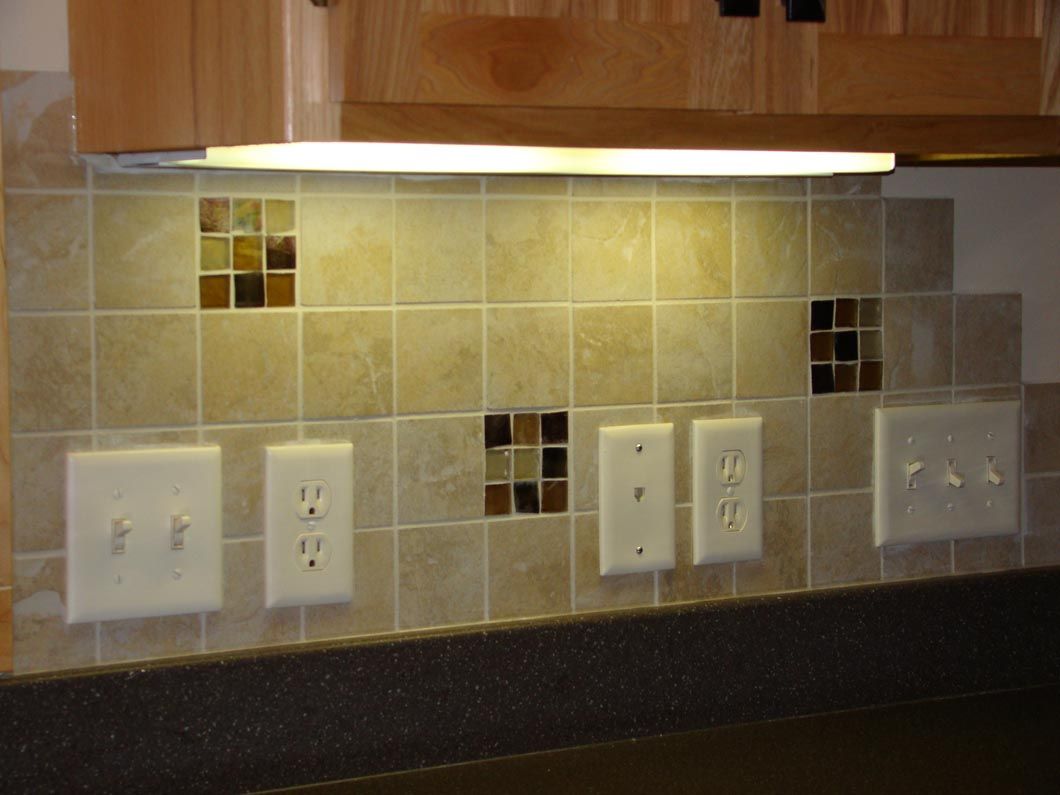 A kitchen with a lot of electrical outlets and a light