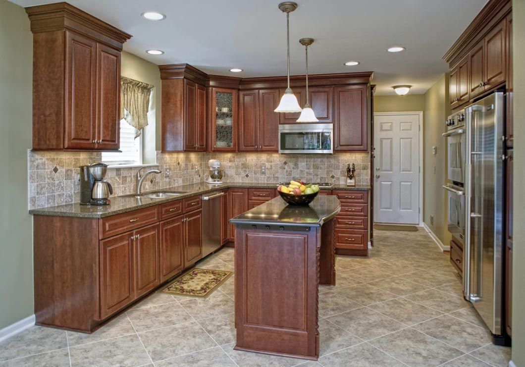 A kitchen with stainless steel appliances and wooden cabinets