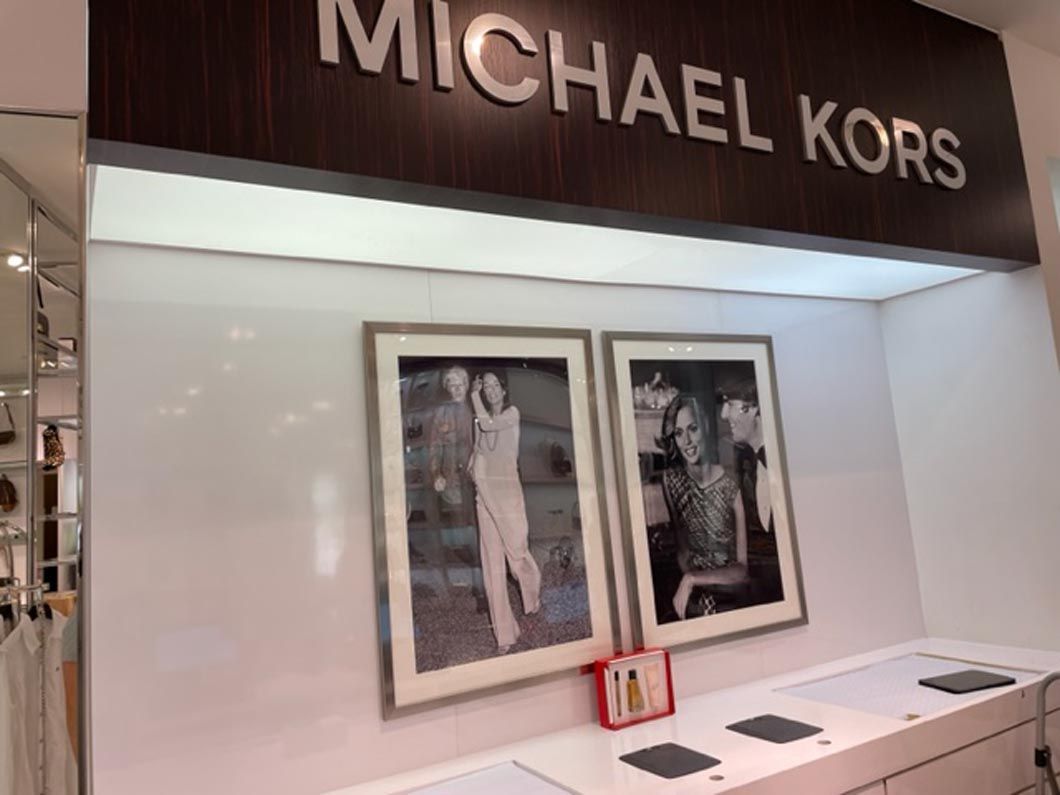 A michael kors store with pictures on the wall