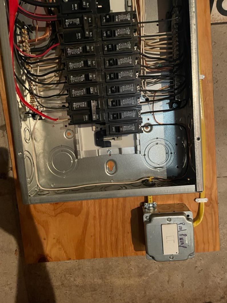 A electrical box is sitting on top of a wooden table.