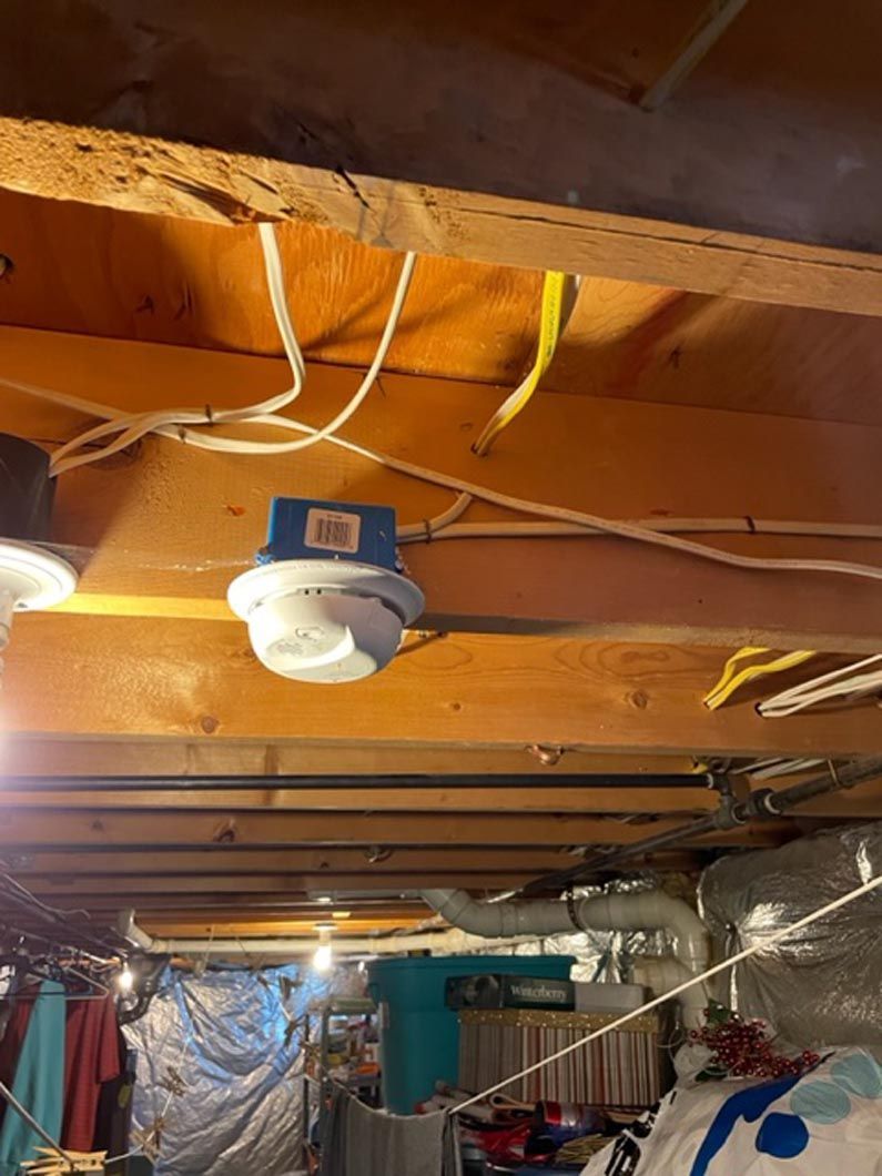 A ceiling fan is hanging from the ceiling of a garage.