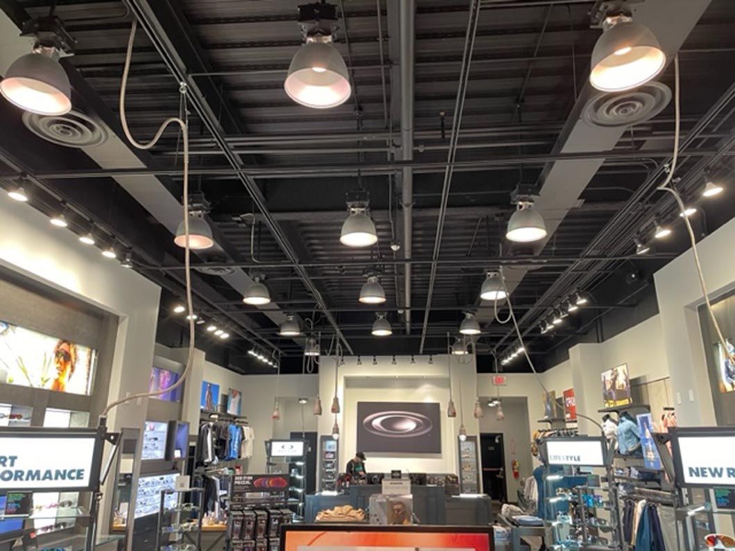 A store with a lot of lights hanging from the ceiling.