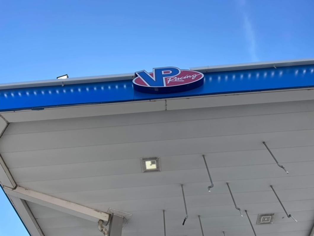 The roof of a gas station with a blue and red logo on it.