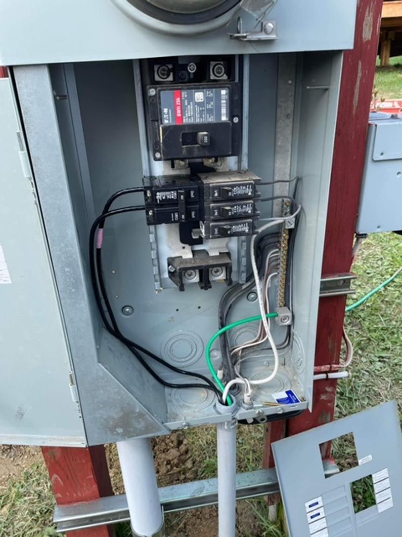 A close up of a electrical box with wires coming out of it.