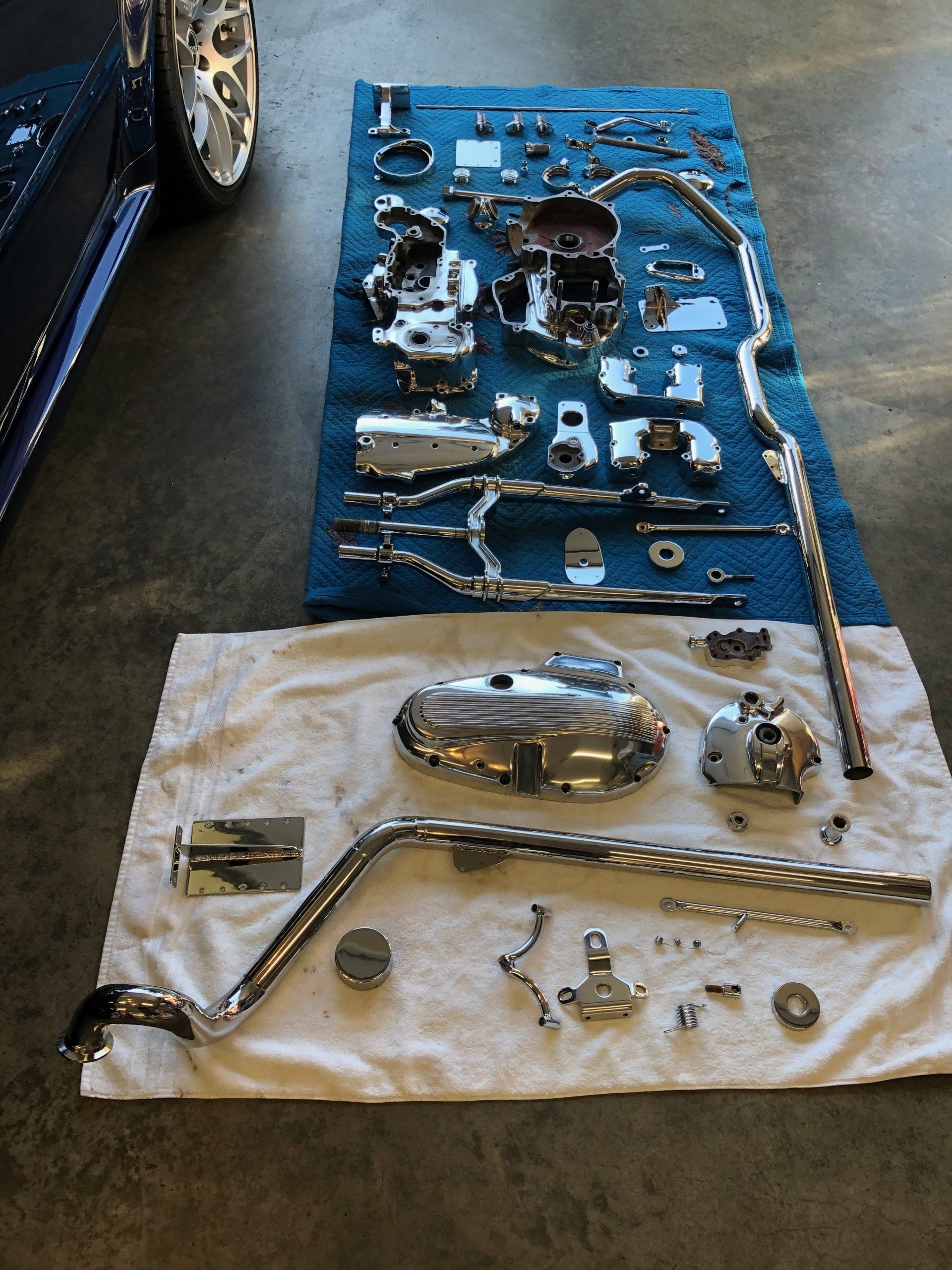 Parts of a motorcycle are laid out on a towel