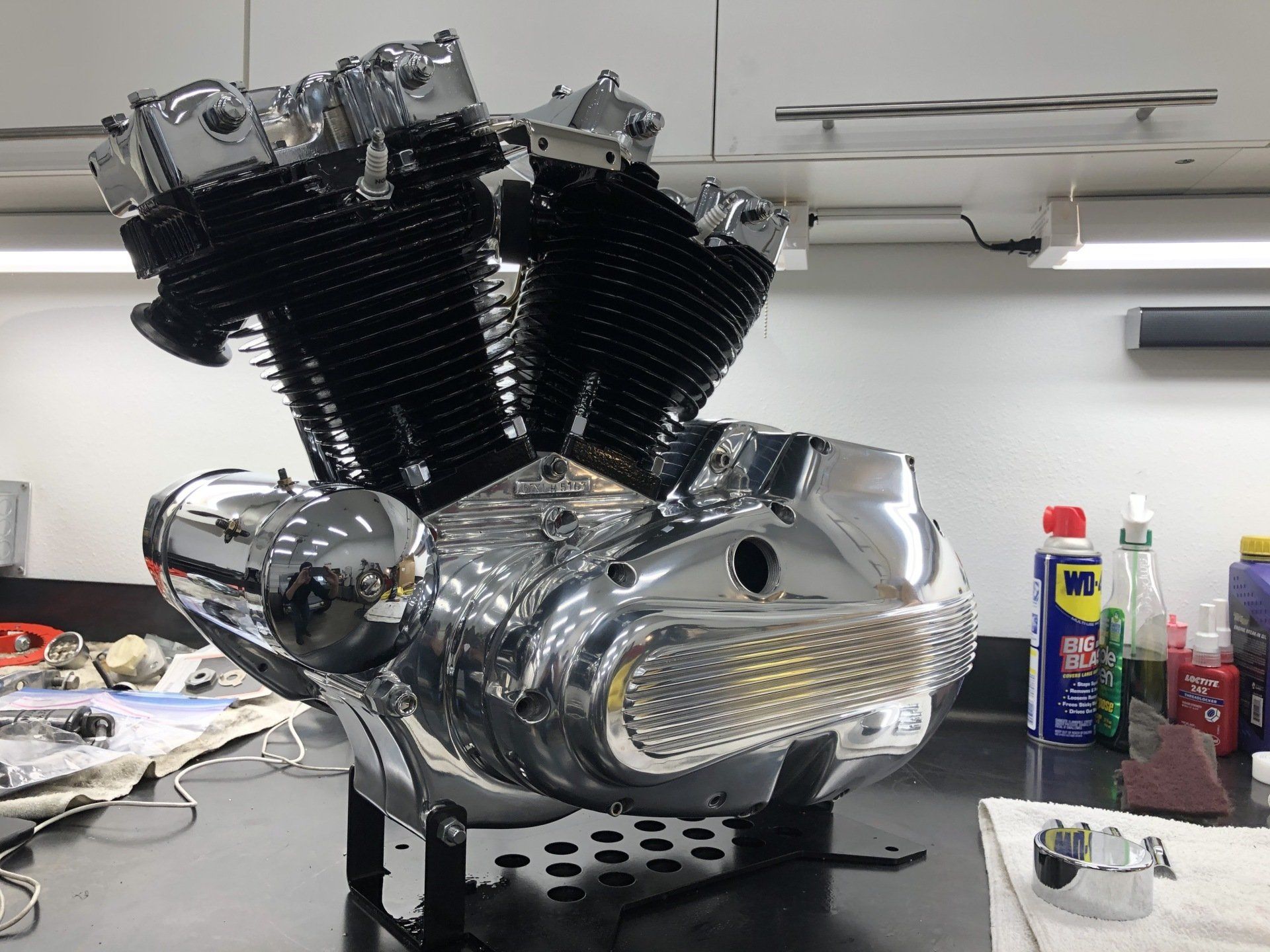 A motorcycle engine is sitting on a table in a kitchen.
