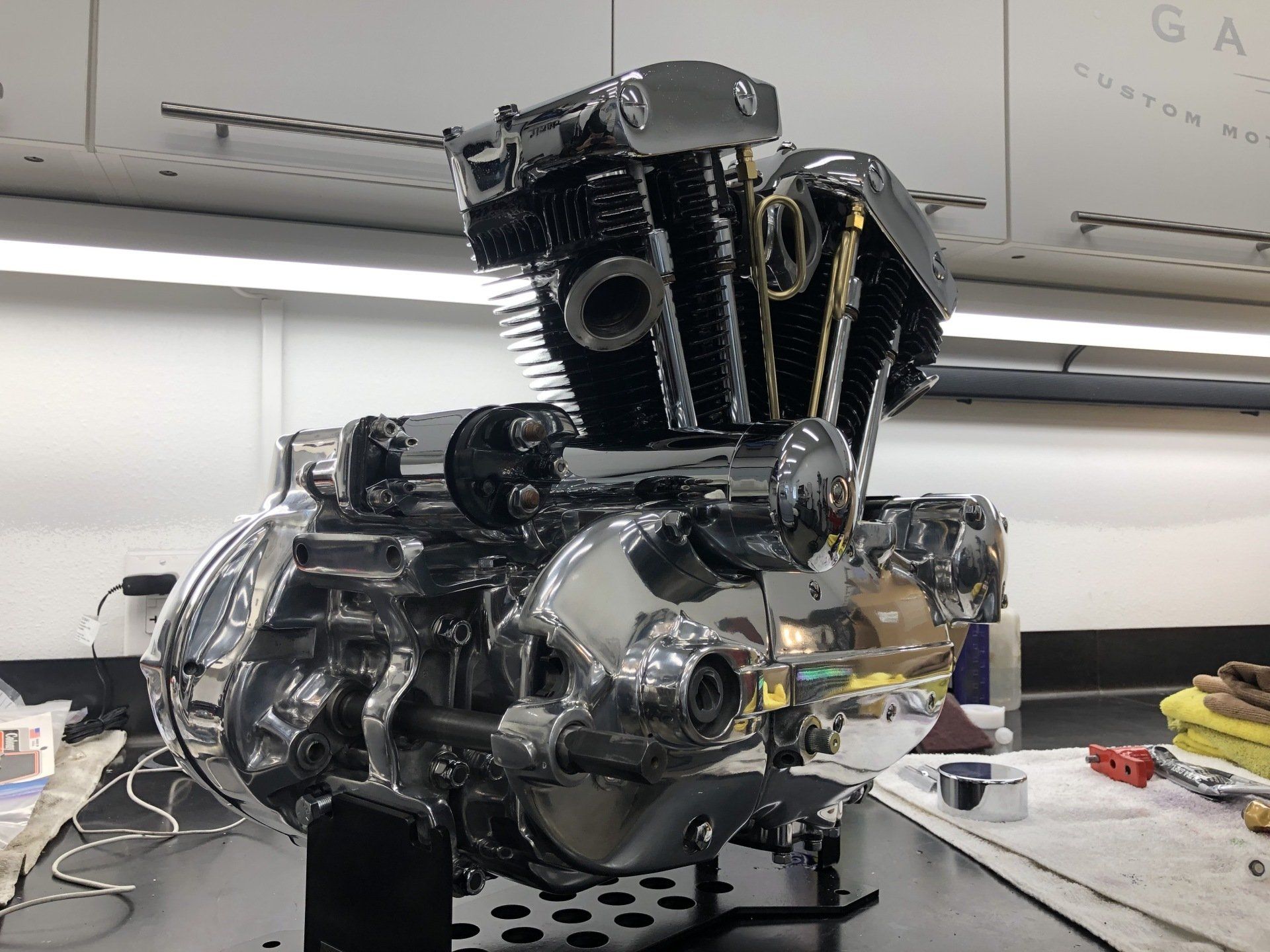 A motorcycle engine is being worked on in a garage