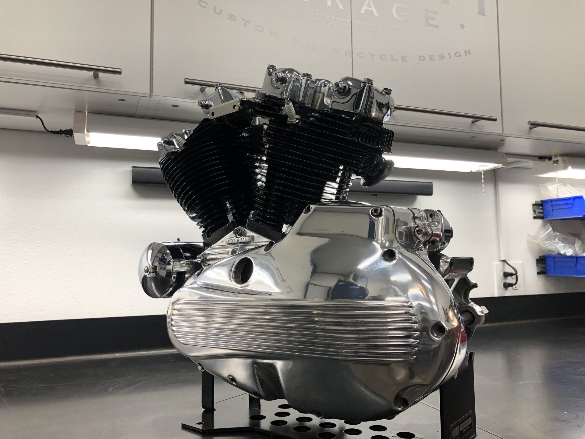 A motorcycle engine is on display in a garage