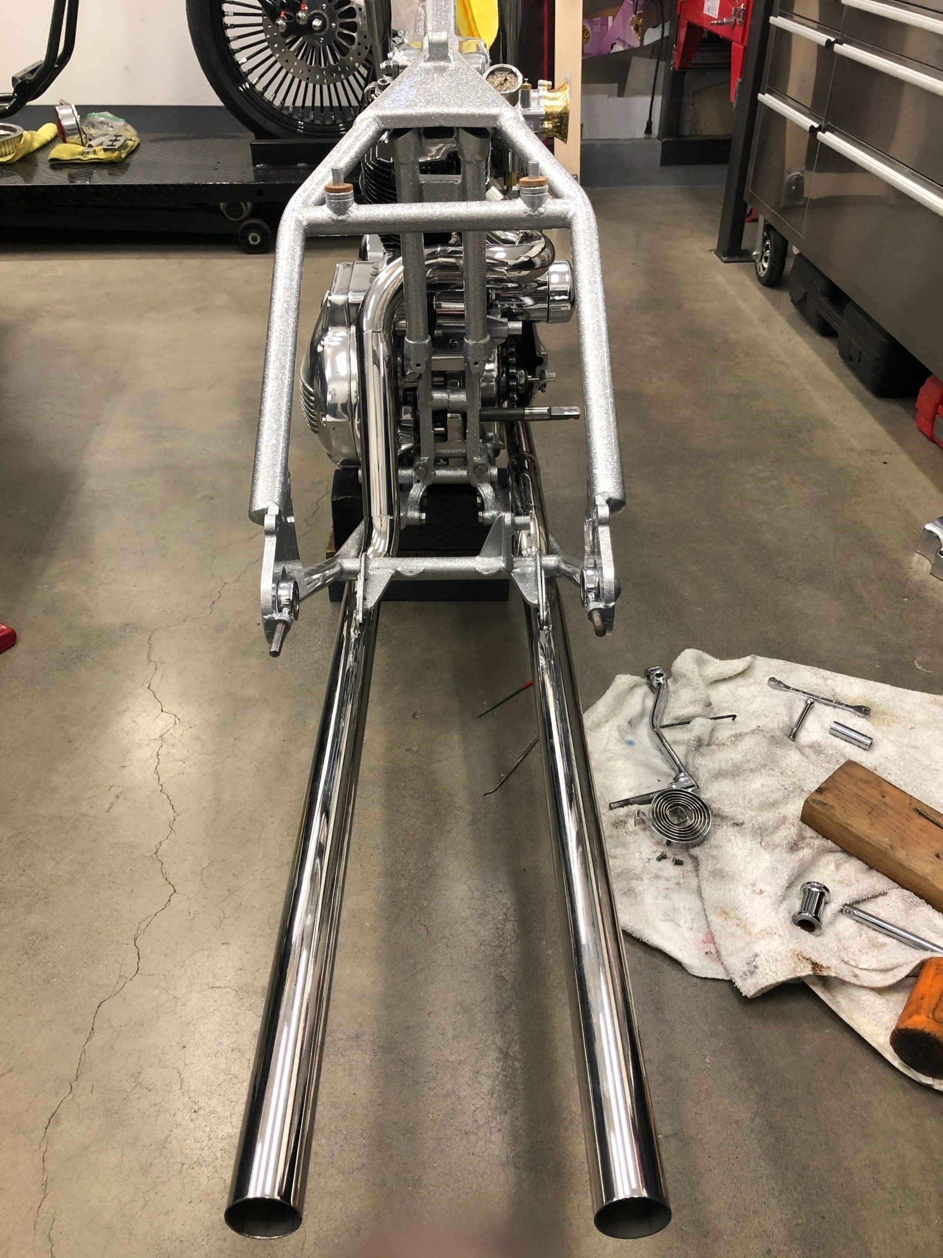 A motorcycle is being worked on in a garage.