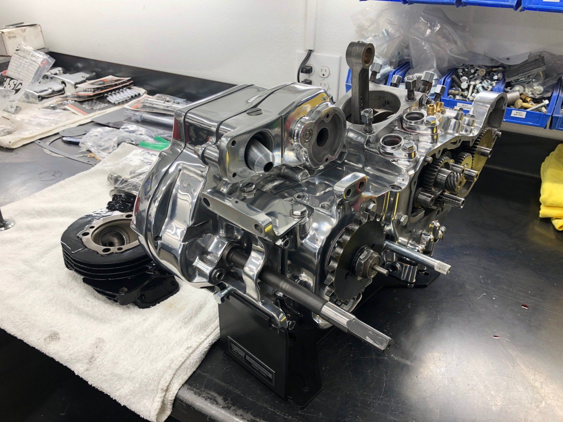 A motorcycle engine is sitting on top of a towel on a table.