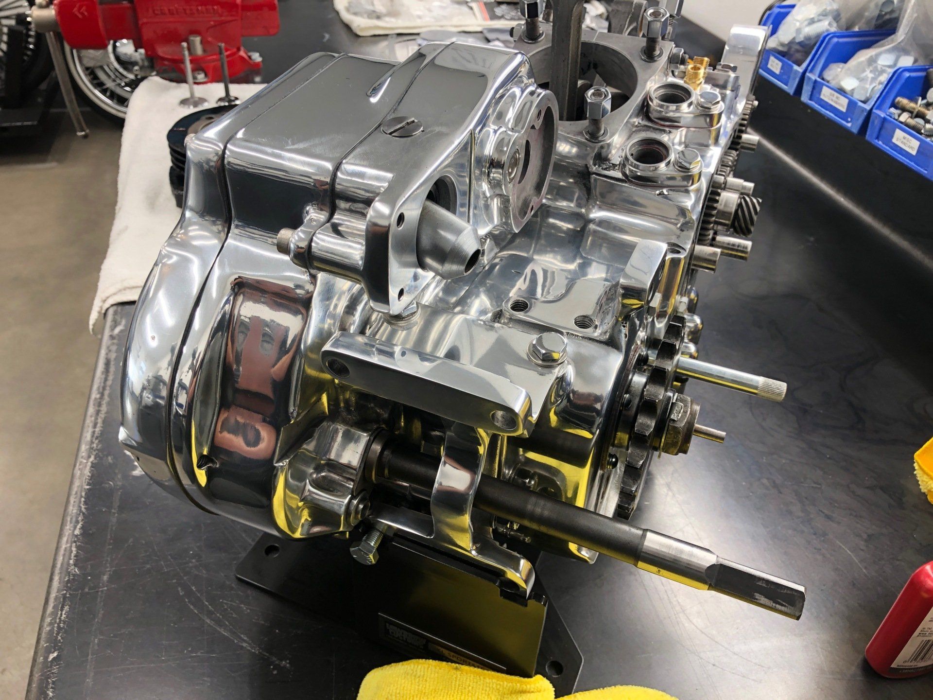 A chrome engine is sitting on top of a black table.