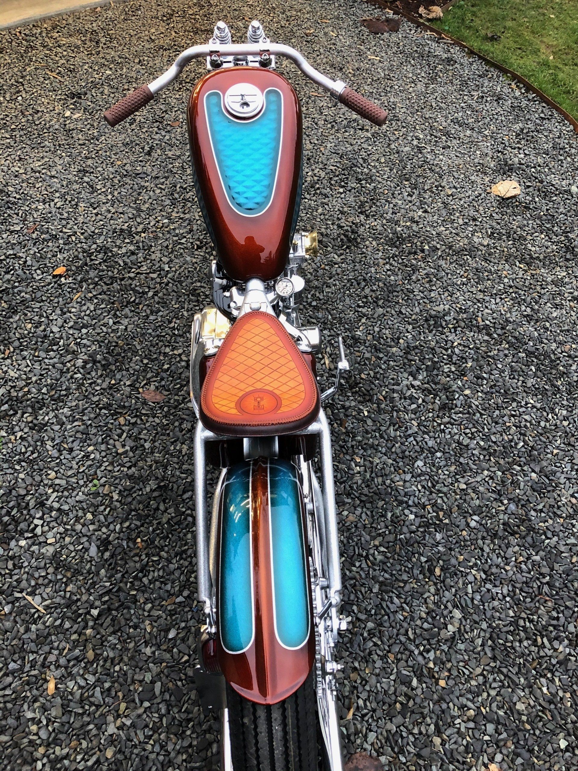 A motorcycle is parked on gravel in a driveway.
