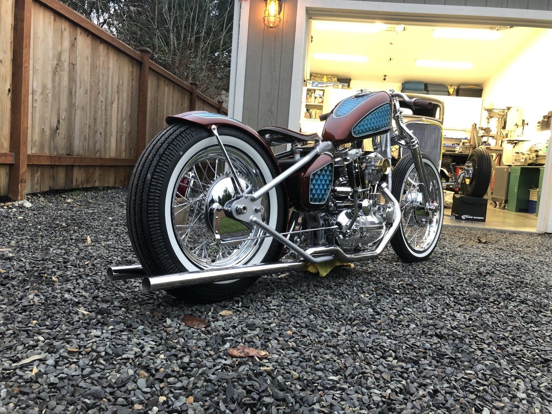 A motorcycle is parked in front of a garage.